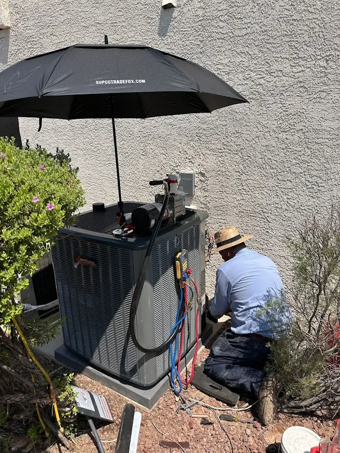 HVAC technician performing outdoor AC maintenance in Waukee